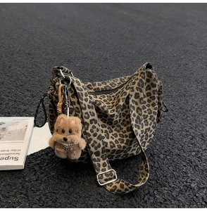 Close-up of leopard print canvas bag with a cute brown plush bear charm detail