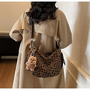 Detail of hobo crossbody bag with leopard print canvas and plush bear charm accent