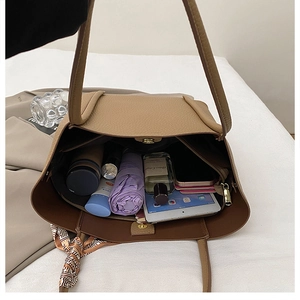 Internal view of khaki tote bag with zipper compartment showing large storage capacity