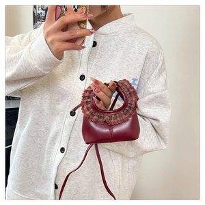 Close-up of wine red mini bag featuring plaid ruffled handle and glossy PU leather finish