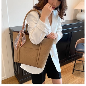 Brown leather tote bag with lychee texture and geometric patterned scarf detail