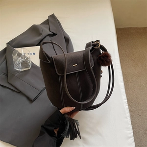 Vintage dark brown matte bucket bag with contrast stitching and plush ball charm