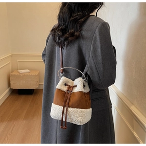 Detail of plush contrast bucket bag with lamb wool trim and silver ring handle