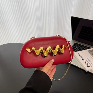 Red acrylic wave shoulder bag with gold chain strap for elegant evening parties