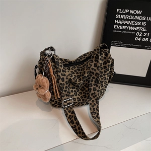 Retro leopard print canvas crossbody bag with adjustable strap and cute bear pendant