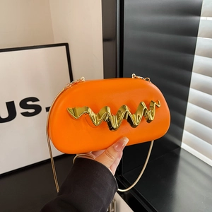 Bright orange acrylic clutch bag with gold chain strap and wavy metal accent detail