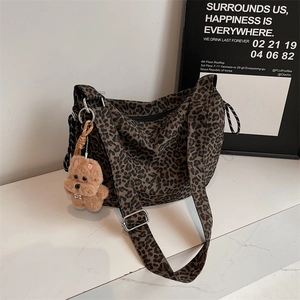 Retro leopard print crossbody bag with wide strap and brown bear plush keychain