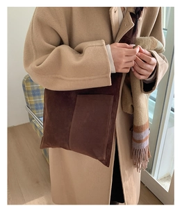 Brown suede tote bag with large front pocket styled with a wool coat for autumn