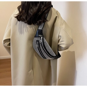 Close-up of black rhinestone crossbody bag featuring a V-pattern wide shoulder strap