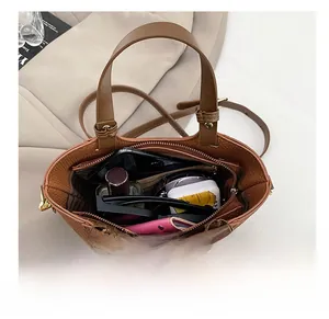 Interior view showing large capacity of the brown tote bag with various accessories