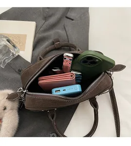 Interior view of brown suede crossbody bag showing capacity for phone and wallet