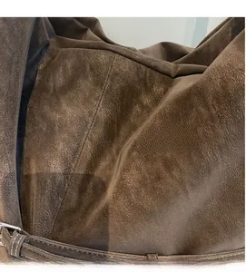 Macro detail of soft vintage brown suede fabric showing fine texture and supple grain