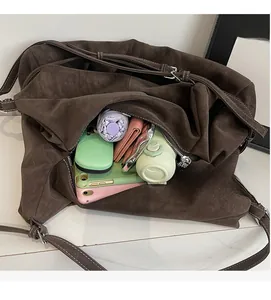 Spacious interior of a brown suede tote bag showing storage capacity for daily essentials