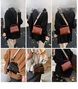 Model showcasing vintage crossbody bags with wide patterned straps in an autumn setting