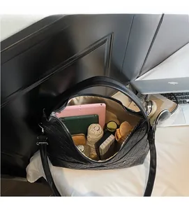 Interior view of large capacity black woven tote bag showing spacious storage for essentials