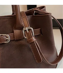Close-up of premium dark brown pebbled leather texture and silver buckle detail