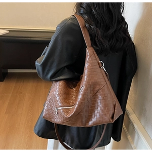 Detailed close-up of brown woven texture on large capacity PU leather shoulder tote bag