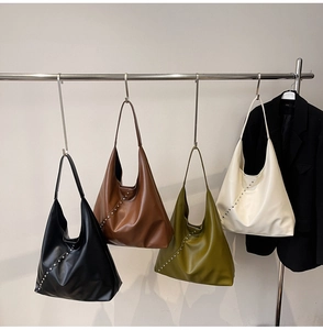 Detail showing four leather hobo bags with silver studs in black, tan, olive and beige