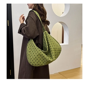 Detail of green polka dot shoulder bag with large capacity and crescent structure