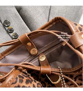 Detail shot of leopard print bucket bag featuring a strong magnetic closure and gold hardware