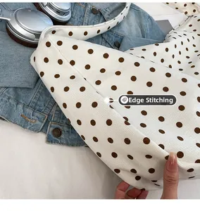 Detail of polka dot tote bag featuring pressed edge process and corduroy texture