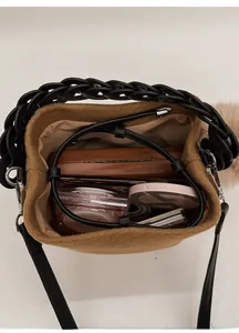 Top view of compact brown bucket bag showing interior space for cosmetics and essentials