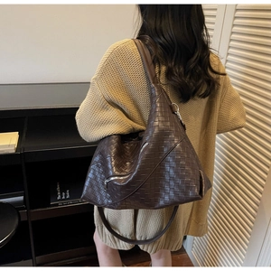 Detail of dark brown woven texture shoulder bag with premium checkered craftsmanship