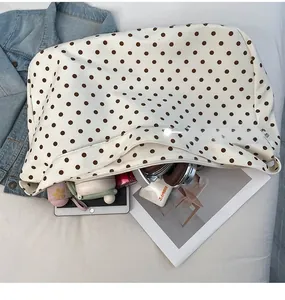 Interior view of polka dot tote bag showing storage for laptop, bottle and books