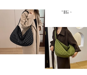 Close-up of hobo shoulder bags in black and green with polka dot prints and wide straps