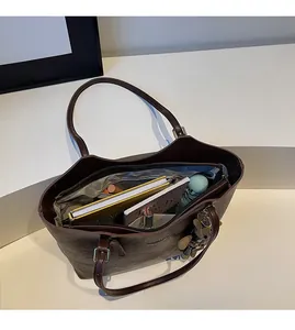 Top view of spacious deep brown tote bag interior with multiple organizational pockets