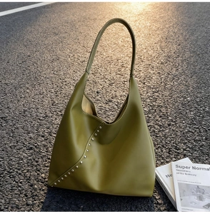 Detailed view of avocado green Hobo bag with silver metal studs and smooth PU texture