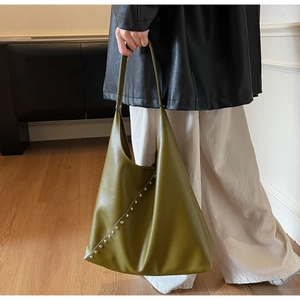 Detail of olive green hobo bag featuring silver studs and premium matte leather texture