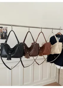Detailed display of vintage tassel tote bags in four colors with braided edge craft