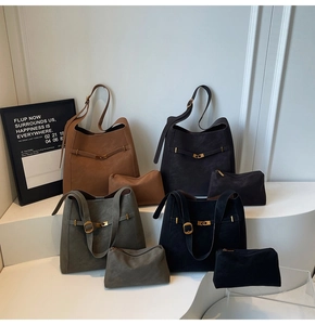 Detail of four matte suede tote bags in earthy tones with matching inner pouches