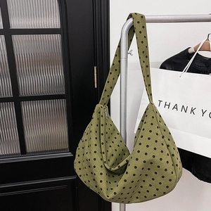 Green canvas tote bag with black polka dots and large capacity for daily commuting