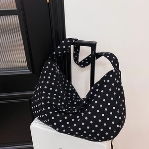 Large black and white polka dot canvas hobo bag for daily commute and travel