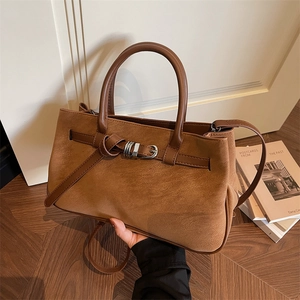 Brown vintage matte tote bag with leather handles and decorative silver buckle closure