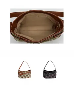 Detail view of the interior zip pocket and lining of the plaid patchwork shoulder bag