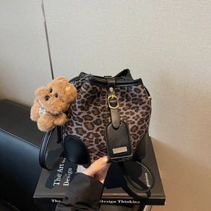 Retro leopard print suede bucket bag with black leather trim and cute bear charm