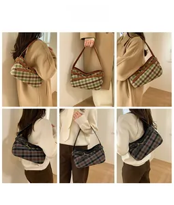 Detail of plaid wool shoulder bag with metal hook closure and leather strap accents