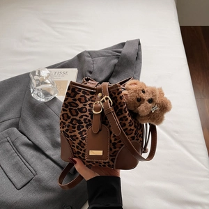 Vintage leopard print faux suede bucket bag with leather trim and bear pendant