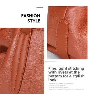 Detailed view of brown lychee grain leather texture with precise stitching and bottom rivets