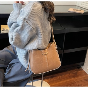Detailed back view of a brown vintage leather hobo bag with adjustable wide shoulder strap