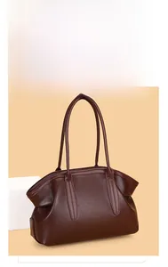 Detailed macro view of the dark brown lychee texture and stitching on the tote bag