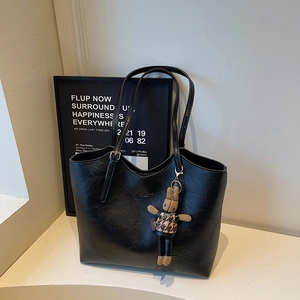 Retro black tote bag with glossy wrinkled leather and cute rabbit plush pendant accessory