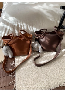 Litchi texture leather bucket bags in tan and dark brown with cute bunny pendant details