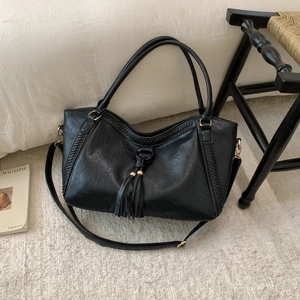 Retro black tote bag with woven lines, double tassels and adjustable shoulder strap