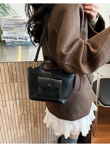 Minimalist black leather crossbody bag for women with an adjustable strap and front pocket