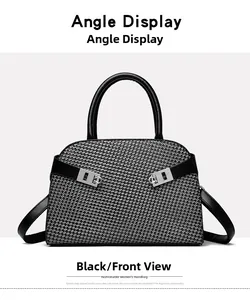 Close-up of black and white houndstooth handbag with silver metal buckles and leather handles