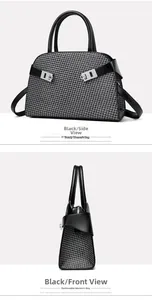 Detail view of the houndstooth pattern bag with black leather trim and silver metal buckle